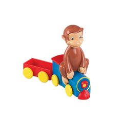 a monkey sitting on top of a toy train