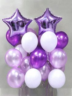 purple and white balloons are arranged in the shape of a star on top of each other