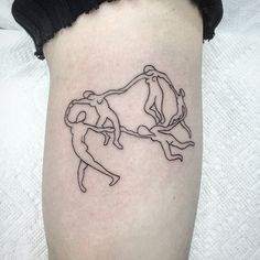 a woman's leg with a tattoo of two people holding each other on it