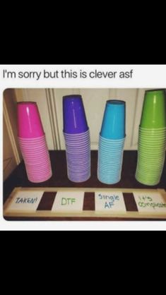 there are many different colored cups on the counter top, and one is saying i'm sorry but this is clever asf