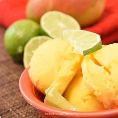 a bowl filled with pineapple sorbet next to limes and an orange towel