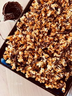 a tray filled with chocolate covered popcorn on top of a table