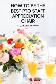 a table topped with flowers and glasses filled with orange juice