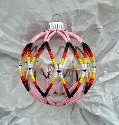 a christmas ornament made out of beads