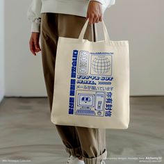 a person holding a bag with an advertisement on it