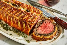 a meatloaf is cut into slices and served on a platter with a knife