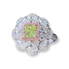 This exquisite ring is a true work of art, featuring a brilliant fancy green-yellow diamond set in a stylish halo piece and encrusted with rounds, marquise, and trillion shaped white diamonds. The unique combination of diamond shapes creates a modern and elegant look that is sure to catch the eye. The 18K white gold setting adds a touch of luxury and sophistication, making this ring the perfect choice for a special occasion or everyday wear. Whether you're looking for a statement piece or a time Luxury Green Marquise Diamond Ring, Green Marquise Diamond Ring Fine Jewelry, Luxury Green Cluster Ring With Center Stone, Green Diamond Cut Diamond Ring, Luxury Green Rings With Diamond Accents, Dazzling Green Diamond Ring, Exquisite Green Diamond Ring With Brilliant Cut, Green Marquise Diamond Ring For Formal Occasions, Dazzling Green Diamond Cut Ring