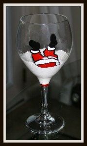 a wine glass with a face painted on it