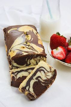 a chocolate swirl cake with strawberries next to it