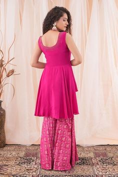 Hot pink crepe peplum top with cutdana hand embroidery. Comes with banarasi brocade sharara. - Aza Fashions Pink Sharara With Resham Embroidery, Pink Sleeveless Sets With Mirror Work, Pink Anarkali Dress With Peplum Shape, Pink Anarkali Peplum Dress, Festive Pink Georgette Top, Pink Sleeveless Dress For Diwali, Sleeveless Pink Dress For Diwali, Fitted Sleeveless Pink Palazzo Set, Pink Fitted Sleeveless Palazzo Set