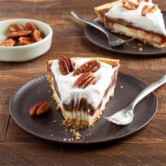 a piece of pecan pie on a plate with a fork and bowl of pecans in the background