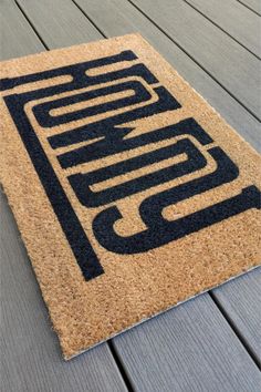 a door mat that has the letter s on it and is sitting on top of a wooden floor