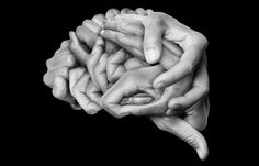 two hands are stacked on top of each other in the shape of a human brain