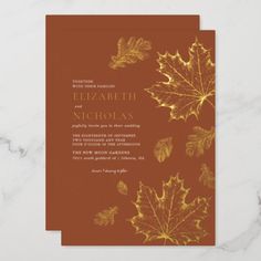 an orange and gold wedding card with leaves on it