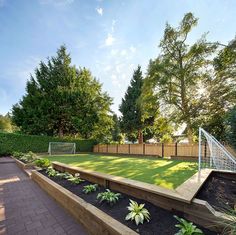 a backyard with a soccer goal and landscaping