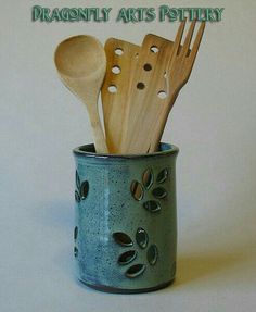 wooden utensils in a ceramic cup with the words dragonfly arts pottery