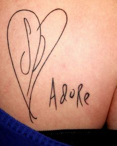 the back of a woman's stomach with her name written in cursive font