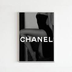 a black and white photo of a woman's legs with the word chanel on it