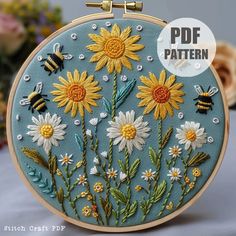 the embroidery pattern has been made with flowers and bees