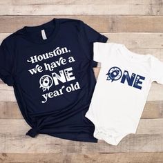 two shirts that say houston, we have a one year old