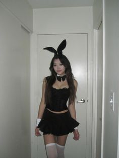 a woman in bunny ears is posing for the camera