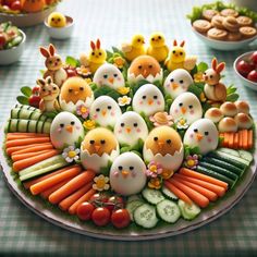 a platter filled with eggs, carrots and cucumbers on top of a table