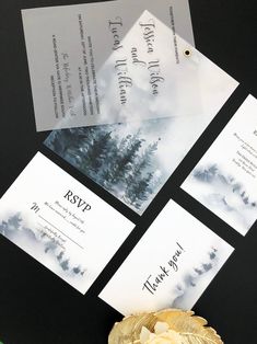 the wedding stationery is laid out on top of each other