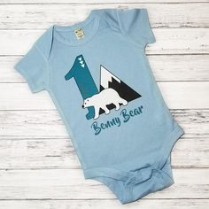 First Birthday Outfits / Baby Polar Bear Onesie / First Birthday / Personalized / Blue Onesie / Baby Bear / Baby Boy Clothes / Blue and Grey  This First Birthday Outfit features an adorable baby polar bear, mountain and number 1 along with the birthday childs name. Its a perfect first Bear Onesie, Baby Polar Bear, Baby Polar Bears, Birthday Personalized, Bear Mountain