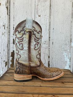 Exude elegance and country charm with Corral Women's Taupe & Beige Python Embroidered Wide Square Toe Cowgirl Boots. These boots are expertly crafted for comfort and style, featuring distinctive embroidery and a wide square toe design. Perfect for any cowgirl looking for a touch of luxury in her wardrobe. VAMP LEATHER: MALAYOPYTHON RETICULATUS LINING: PIG TOE TYPE: WIDE SQUARE TOE SHAFT HEIGHT: 10 1/2" CIRCUMFERENCE: 14.5" HEEL TYPE: COWBOY HEEL HEEL MATERIAL: FIBER GLASS HEEL HEIGHT: 1 1/2" SOL Square Toe Cowgirl Boots, Tall Cowgirl Boots, Womens Ball Caps, Cowgirl Boots Square Toed, Toddler Boy Tops, Black Overlay, Cowgirl Look, Wedding Boots, Youth Shoes