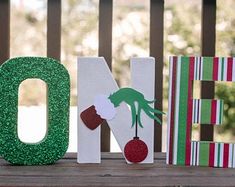 the letters are made out of wood and have green glitters on them, including one for dr seuss