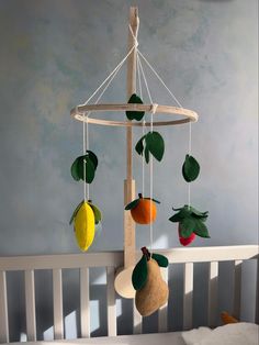 a crib with fruit hanging from it's sides