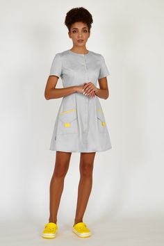 This fashionable uniform dress will make any female doctor or a beautician look stylish and classy when at work. The medical lab coat has a babydoll design, a full skirt, and 3/4 sleeves. The scrub dress has contrast snap fastening. The dress is complemented with laconic and roomy patch pockets that are trimmed with contrast fabric. The fabric is 70% cotton, 30% polyester, made in the Netherlands. Your customers will get aesthetic pleasure when communicating with you wearing this apparel, while Esthetician Uniform, Dentist Clothes, Cleaning Uniform, Scrub Dress, Women Doctor, Nurse Dress Uniform, Scrubs Nursing Uniforms, Best Uniforms, Doctor Coat