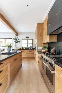 a kitchen with wooden cabinets and black counter tops