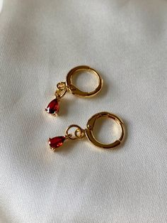 "18K gold plated teardrop ruby drops huggie hoops which are beautifully shiny under the sunlight. 23mm total length *Nickel free 👀 Details 👀 * Materials : 18K gold plated brass, Ruby * Hoop style * 10mm hoop diameter ; Ruby : 4 mm (w) x 7 mm (h) * Product is non-returnable for hygiene ⚠️Tips for caring⚠️ -Keep jewelry dry (Avoid contact liquid) -Store difference type of jewelry separately -Store jewelry in a small zip lock bag 📦 Packaging 📦 These earrings will arrive in small paper-based pac Hoops With Charms, Huggies Hoop Earrings, Hygiene Tips, Bride Earrings, Crystal Hoop Earrings, Earrings Christmas, Classy Jewelry, Jewelry Lookbook, Amethyst Earrings