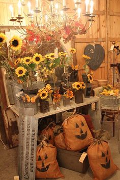 sunflowers and pumpkins are on display in an antique store