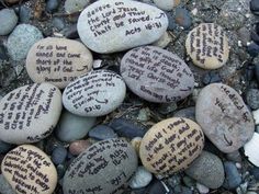 some rocks with writing on them sitting on the ground