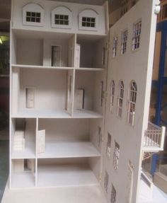 a doll house is shown with all the furniture in it's display case and shelves