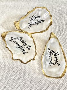 three oyster shells with writing on them