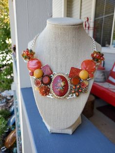 "My Momma and I made this statement bib necklace using broken pieces of new and old pieces of jewelry!  It's perfect for any special occasion or to wear any day!  Handmade repurposed necklace silver tone metal statement bib necklace. Made with broken & newer pieces of jewelry, brooches, pins earrings, and lobster clasp.   It has a cameo with roses **If you live outside the USA message me and I'll give you a shipping quote.** *Look us up on Facebook at:  \"Sparkle my Glitter\" to see more of our Pins Earrings, Repurposed Necklace, Flowers Orange, Broken Pieces, Statement Bib Necklace, Bib Necklaces, Necklace Unique, Upcycled Jewelry, Bib Necklace