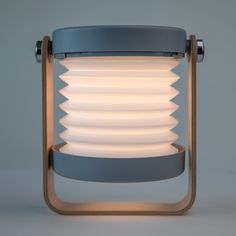 a light that is sitting on top of a metal stand with white plates in it