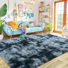 a living room filled with lots of furniture and decor on top of a hard wood floor