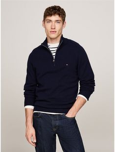 Tommy Hilfiger men's sweater. Made for luxurious layering, this warm wool sweater features a mockneck with a quarter-zip to enhance its versatility.  Material: 100% Sustainable Wool. Classic Polo Sweater With Half-zip And Ribbed Collar, Classic Half-zip Winter Sweater, Classic Half-zip Polo Sweater With Ribbed Collar, Classic Half-zip Sweater With Ribbed Collar, Classic Merino Wool Crew Neck Polo Sweater, Classic Half-zip Polo Sweater With Ribbed Cuffs, Classic Half-zip Sweater With Ribbed Cuffs, Casual Wool Half-zip Sweater, Tommy Hilfiger Classic Winter Sweater