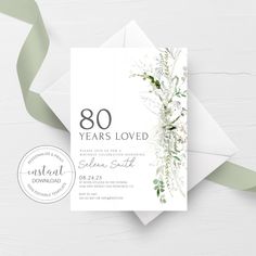 a white and green wedding card with the number 75 years loved written in black on it