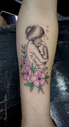 a woman's leg with a tattoo on it and flowers in the background,