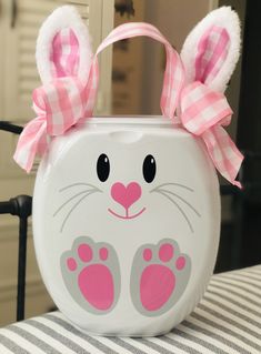 a white container with pink ears and paws on it