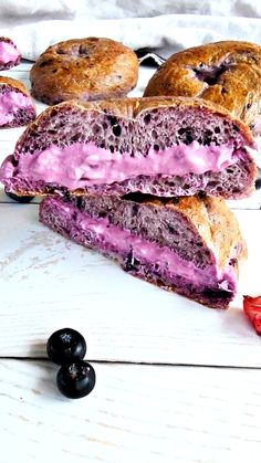 the sandwich is cut in half and ready to be eaten with blueberries on the side