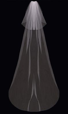 a white veil on top of a black dress with a light coming from behind it