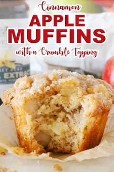 an apple muffin is cut in half and sitting on top of some parchment paper