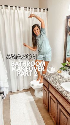 a woman standing on top of a toilet in a bathroom next to a shower curtain