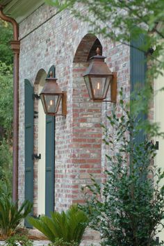 two lights on the side of a brick building